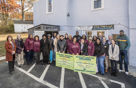 A photo of County Executive Calvin Ball and community members at the launch of the County's Community Refrigerator Program's Pocket Pantry.