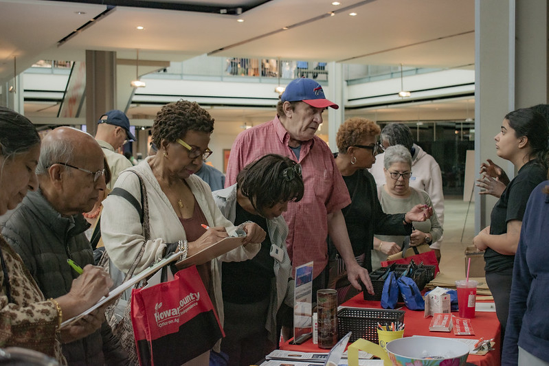 Participants visiting the health department table at event.