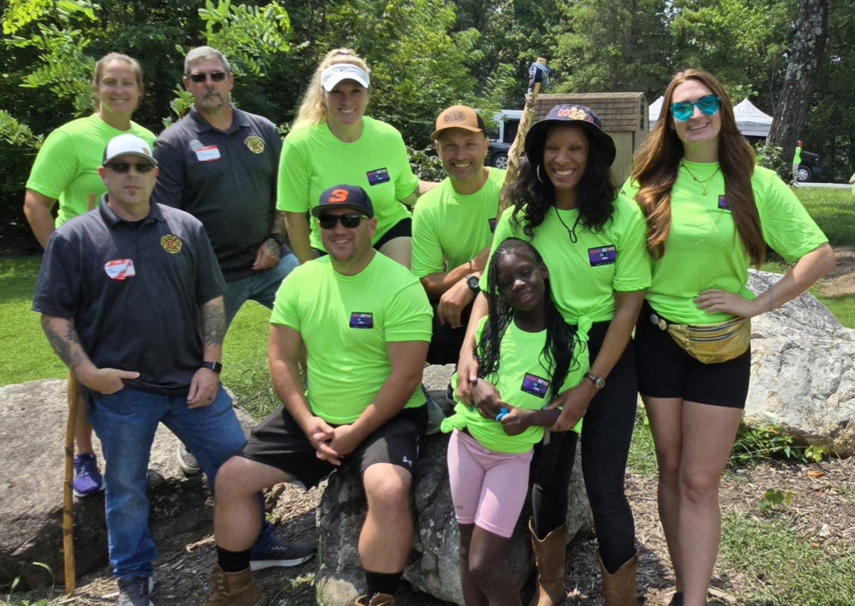Firefighters sit with Burn Camp attendees