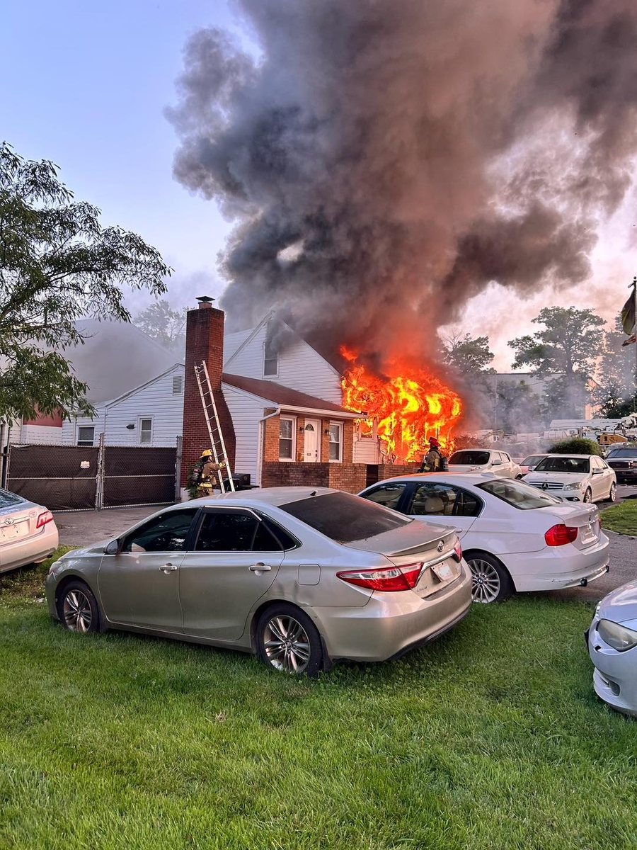 Flames and smoke billowing from single family home