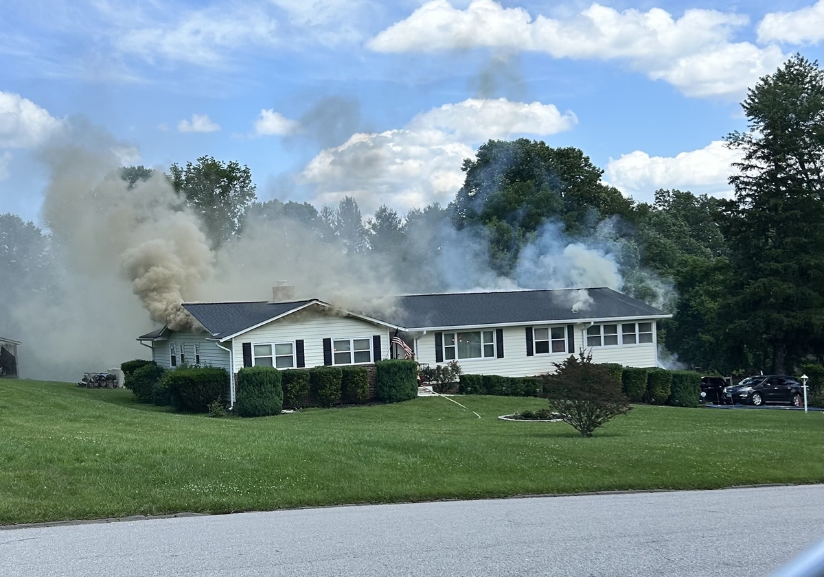Smoke pouring out of single family home