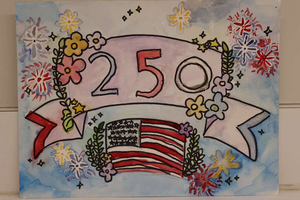 Child's drawing is of the sky with fireworks and a 250th banner. 