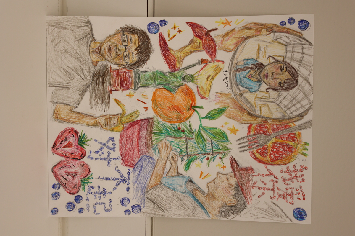 This artwork shows a women planting a plant in a pot. There is a Statue of Liberty drawn as well as an apple core, an orange, a pomegranate and a boy holding a banana. There are also two hands holding a globe with a girl being seen in it.