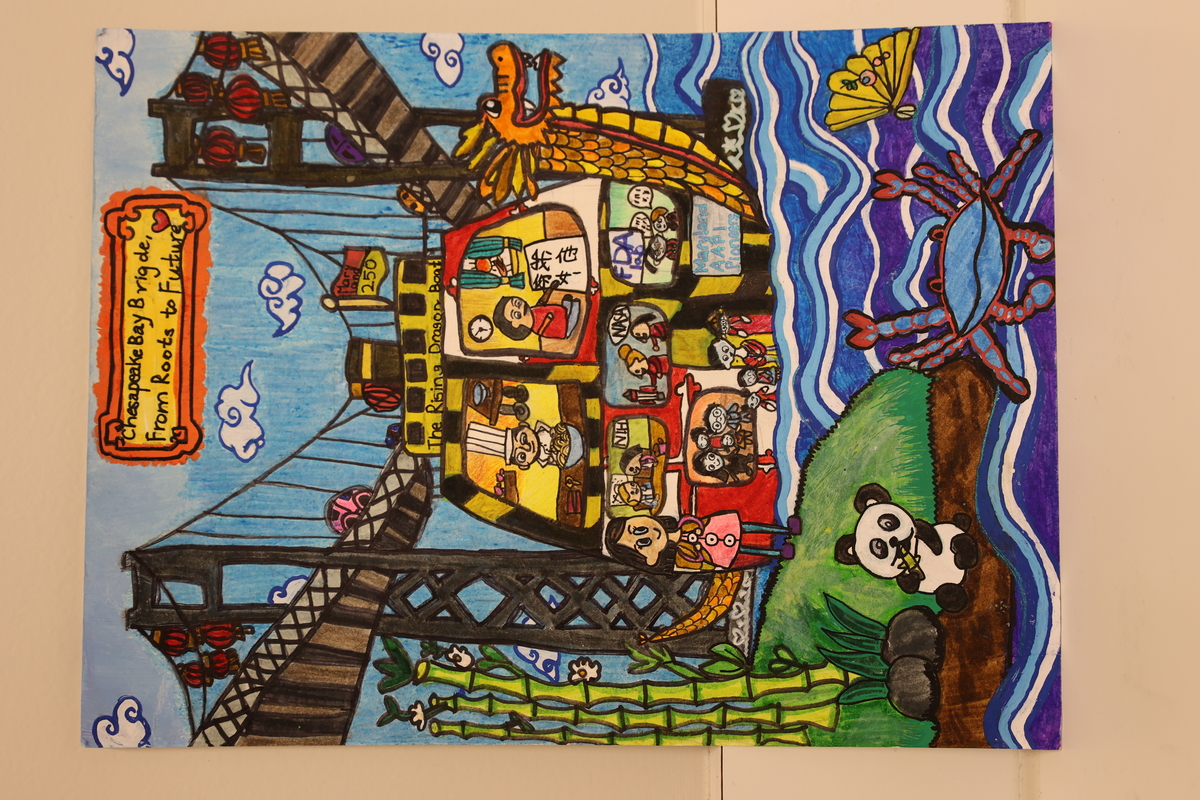 Child's drawing is of a dragon boat sailing under the Chesapeake Bay Bridge.
