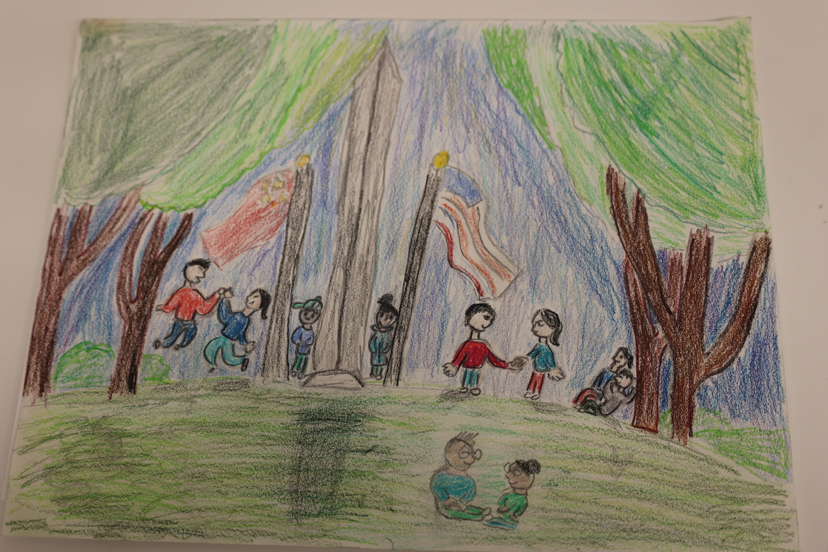 Child's drawing of kids of different backgrounds being together in a park.