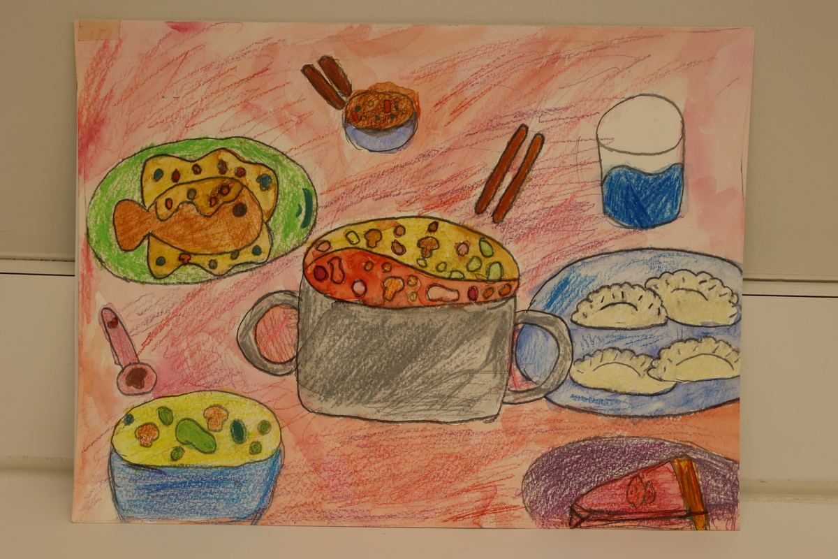 Child's drawing of hotpot and dumplings served on a table.