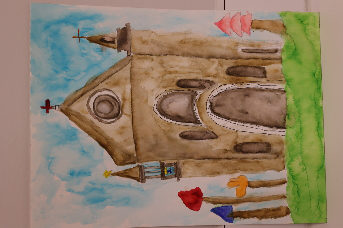 Child's drawing of a church with blue skies and colorful trees next to it.