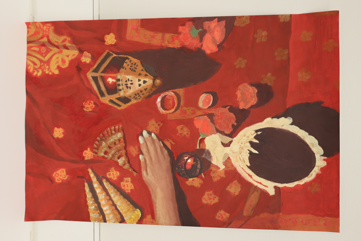This artwork is red in color and has a hand on a table with a mirror on it as well as jewelry and a lantern.