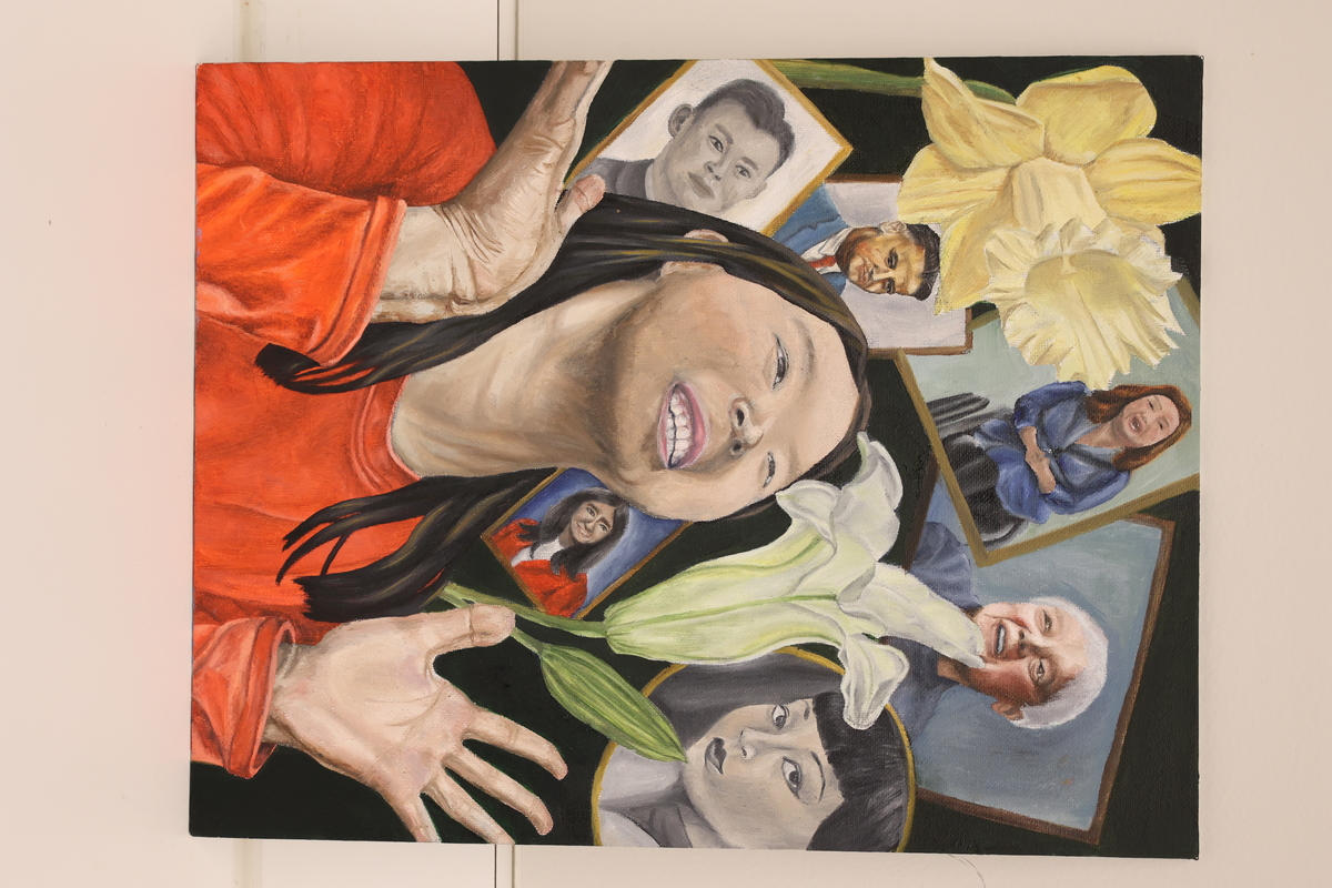 This artwork shows a girl looking at different portraits and two flowers around them.