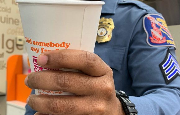 Officer holding a cup