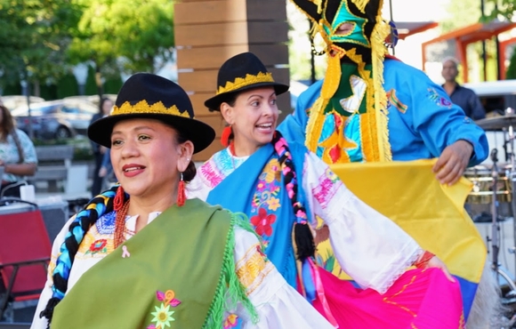 Three dancers in colorful dresses at the 2024 Hispanic Heritage Festival 