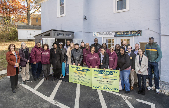 A photo of County Executive Calvin Ball and community members at the launch of the County's Community Refrigerator Program's Pocket Pantry.