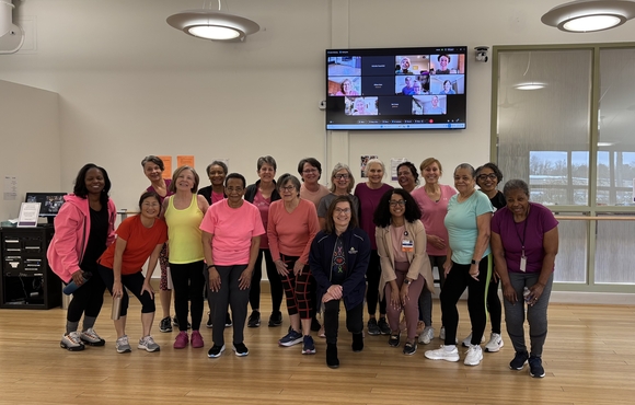 Group photo of about 20 older adult women in workout clothes.