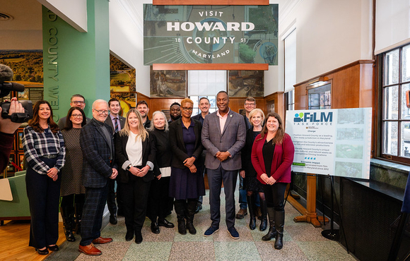 A photo of County Executive posed with members of his new Film Industry and Location Marketing (FILM) Task Force in side the Visit Howard County welcome center.