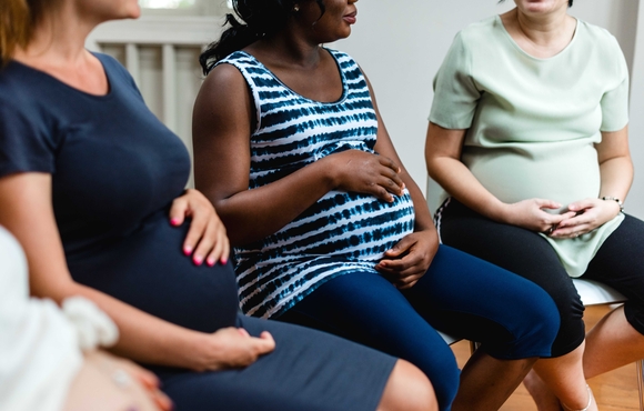 Diverse group of pregnant people in a support group