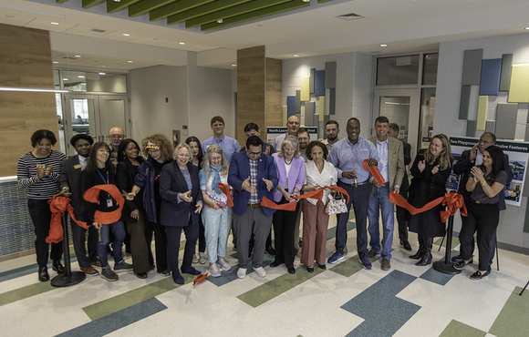 County Executive Calvin Ball with Howard County Government employees, fellow local elected officials, and community members celebrating the red ribbon being cut to mark the opening of the new addition to Recreation & Parks' North Laurel Community Center.