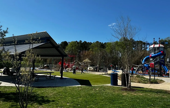 photo of a playground with a picnic pavilion in the foreground