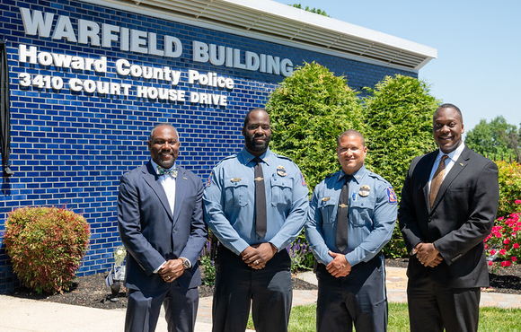 County Executive Calvin Ball (far right) posed out front of the Howard County Police Department's Northern District Warfield Building in Ellicott City with (from left to right) Howard County Council Chairperson Opel Jones, Acting Chief Terrence Benn, and Acting Colonel Antonio Thomas.