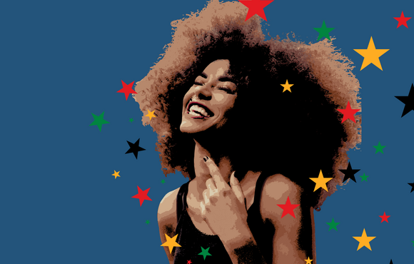 A light skinned Black woman with an afro wearing a black tank top smiles joyfully. 