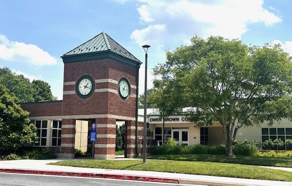 Outside of the Owen Brown Community Center, including the large clock tower