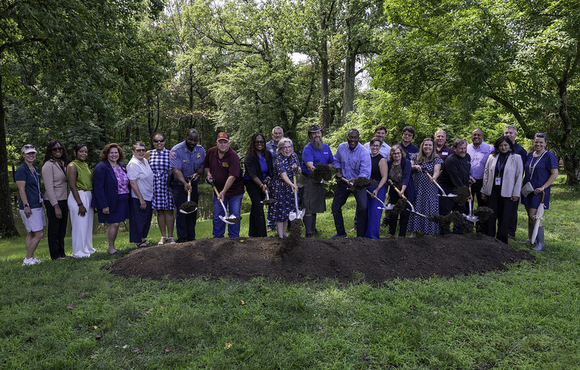 County Executive Calvin Ball posed with other Howard County Government employees and Elkridge community members holding up shovels after just digging into a dirt mound to mark the groundbreaking of the new Elkridge Community and 50+ Center on August 3, 2026.