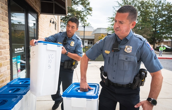 Officers lift containers filled with unwanted medications