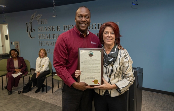 County Executive Calvin Ball posed for a photo with Dr. Maura Rossman together holding up her Executive Proclamation proclaiming October 19, 2026 Dr. Maura Rossman Day in Howard County, Maryland in celebration of her retirement. 