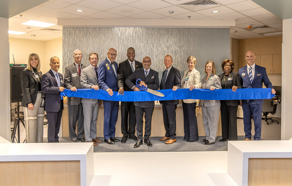 County Executive Calvin Ball and Johns Hopkins Howard County Medical Center personnel and others posed for a picture as they prepare to cut the blue ribbon on the hospital's new Observation Unit.