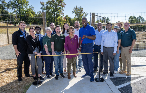 County Executive Calvin Ball pictured with Department of Recreation & Parks' staff members, Columbia Gardeners, and others about to cut the yellow ribbon to officially open the County's new Community Garden at Old Montgomery Road in Ellicott City.