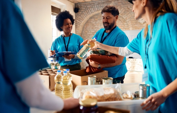 People volunteering to fill boxes with food.