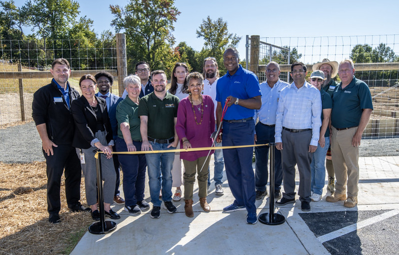 County Executive Calvin Ball pictured with Department of Recreation & Parks' staff members, Columbia Gardeners, and others about to cut the yellow ribbon to officially open the County's new Community Garden at Old Montgomery Road in Ellicott City.