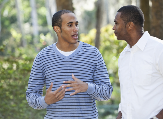 Two men speaking outside