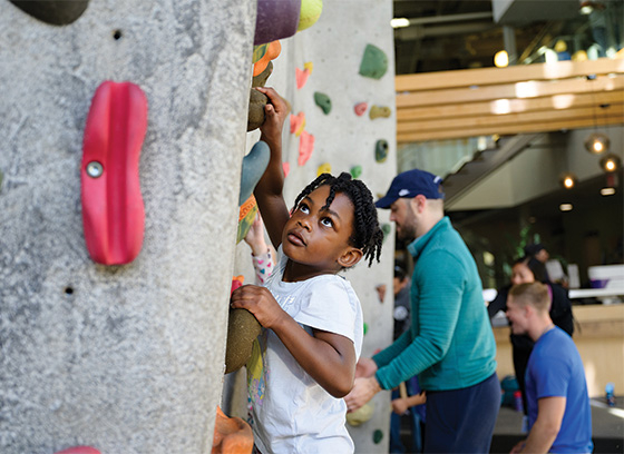 Young child climbing rock wall at Roger Carter Community Center.  