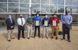 Image of county employees who saved man's life with Calvin Ball in front of Roger Carter Pool