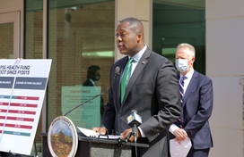 Calvin Ball standing at podium in front of building