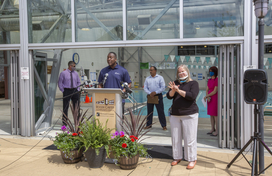 Calvin Ball at podium in front of Roger Carter Center pool