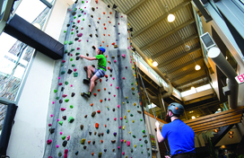 Person climbing indoor rock wall