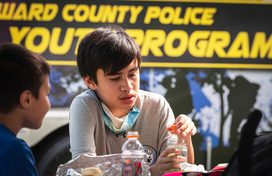 Kids playing in front of Howard County Police Youth Program Van