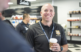Officer smiling with a cup of coffee