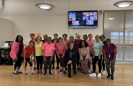 Group photo of about 20 older adult women in workout clothes.