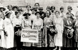 A black and white photo of a group of African American women carrying a sign for voter rights during the suffrage movement in the early 1910's