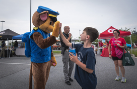 boy high fives costumed character