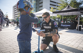 Officer helps a young child with a scooter