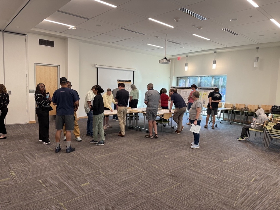 Members of the public gather around display boards at the Elkridge BPPA public meeting
