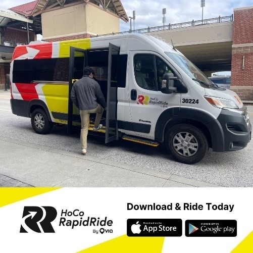 Small transit van with MD colors and markings picking up a person