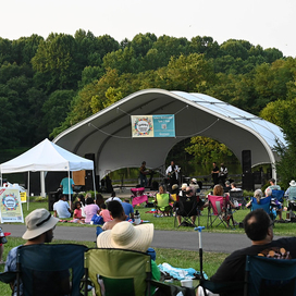 crowd enjoys a concert at the Centennial Park amphitheater