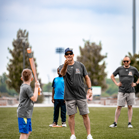 Officer throws ball at batter