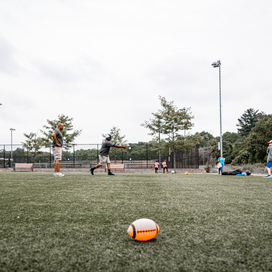 Officers throw ball for young child