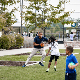 Officer plays football with young child