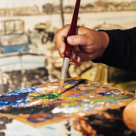 close up of male artist painting oils